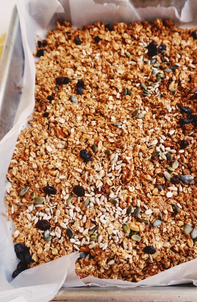 Baked oats, nuts and seeds on baking sheet
