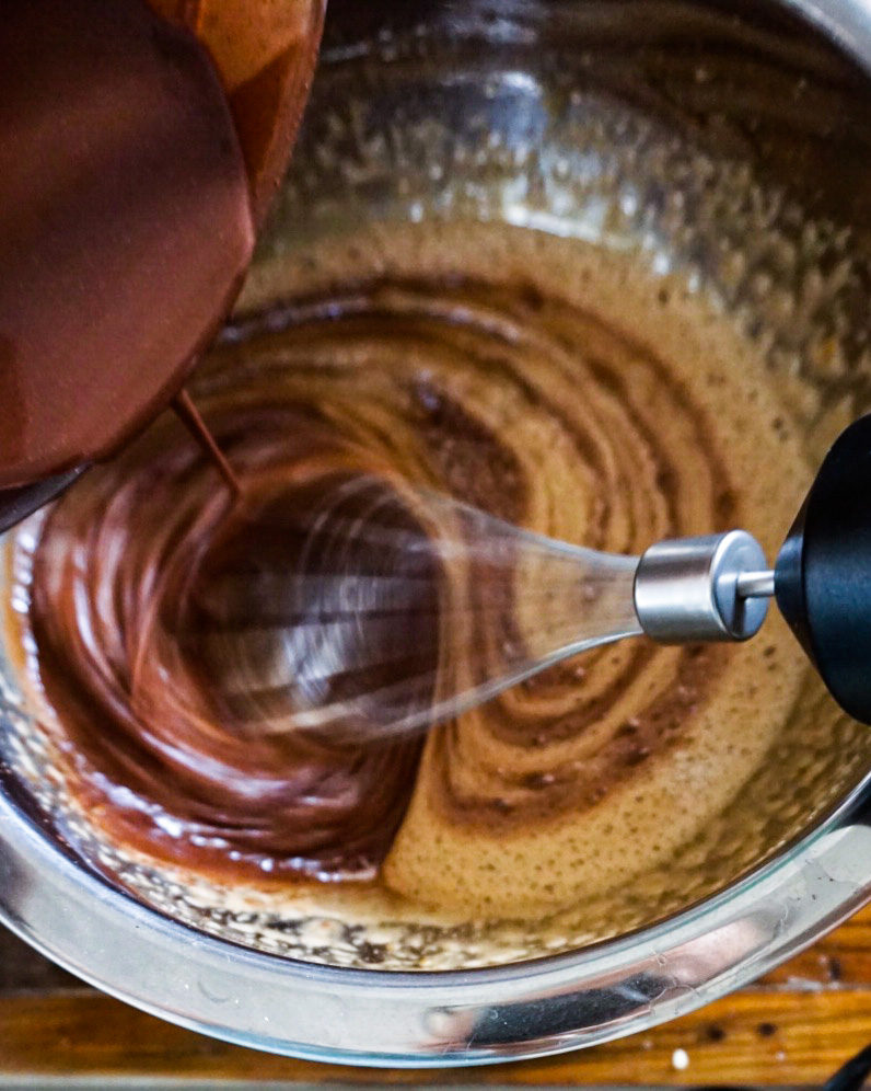 adding chocolate mixture to egg mixture