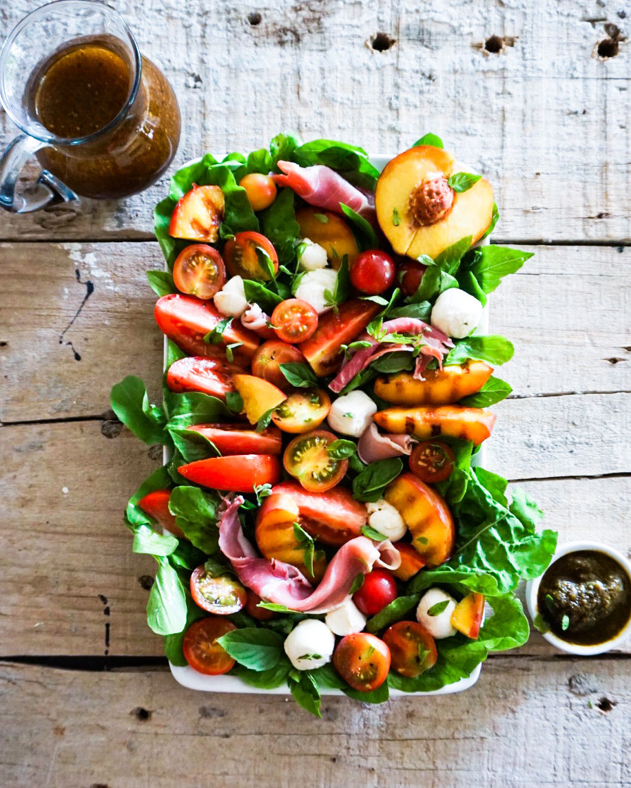 peach caprese salad with dressing and pesto