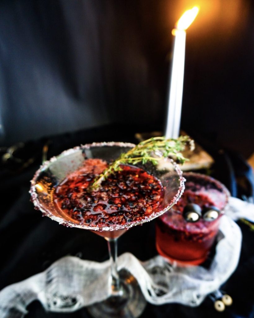 The Morticia, a Halloween's cocktail made with muddled blackberries and champagne and a twig of thyme