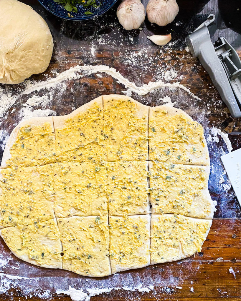 cutting the rolled out dough in 12 squares