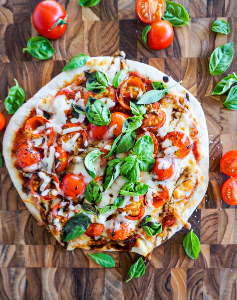 Caprese pizza made with oven roasted tomato sauce