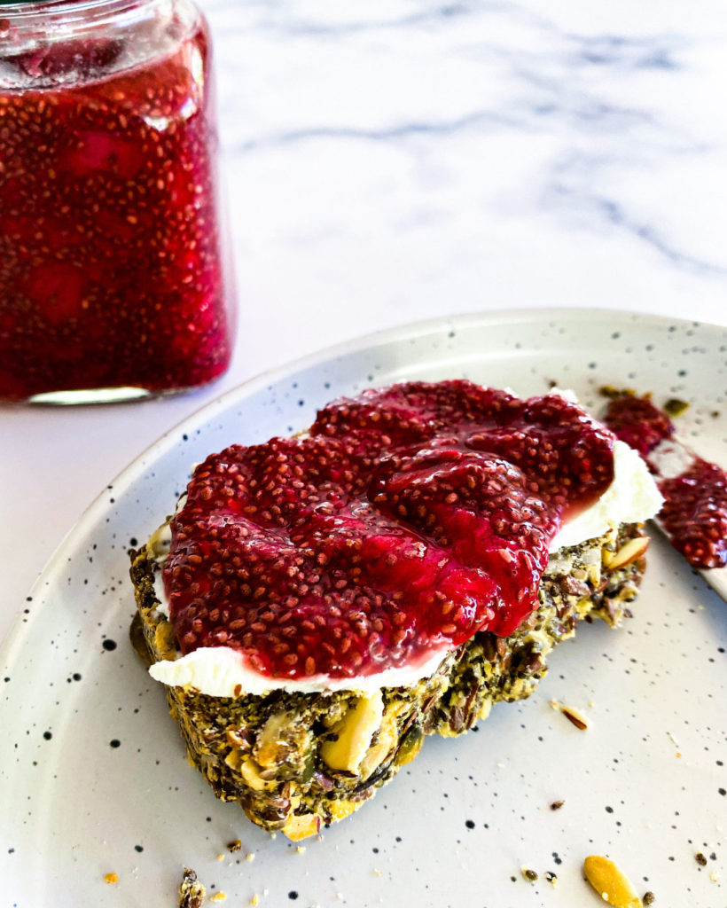 chia jam in a jar and a slice of bread with jam