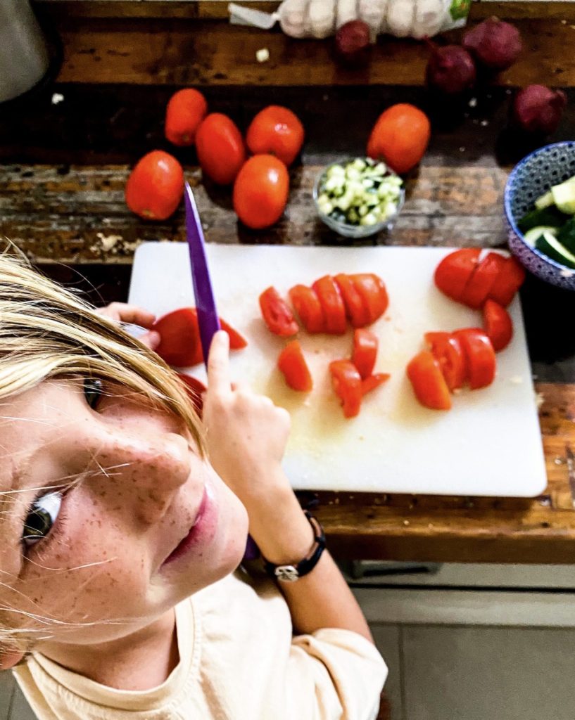 Cooper cutting tomatoes and cucumbers