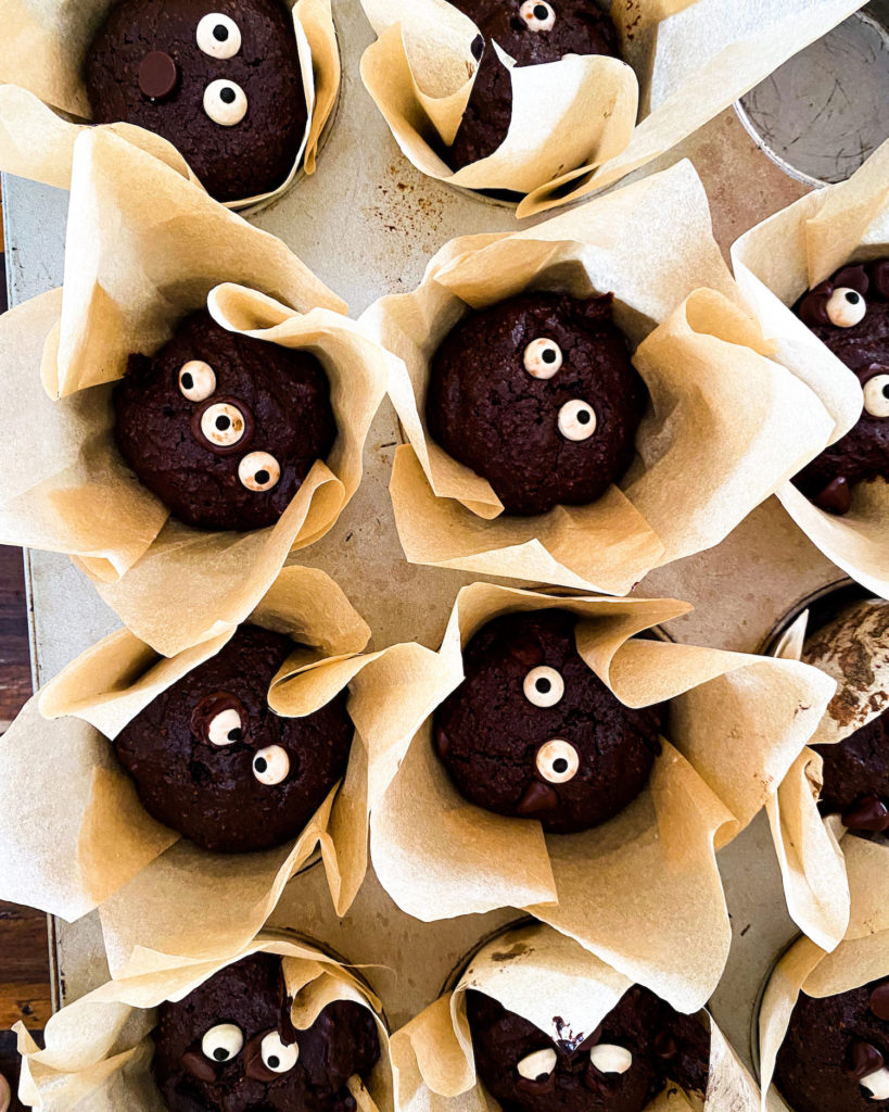 many googly eyed brownie muffins in their wrapper