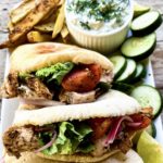 Lemon marinated chicken pitas with oven baked fries and tzatziki