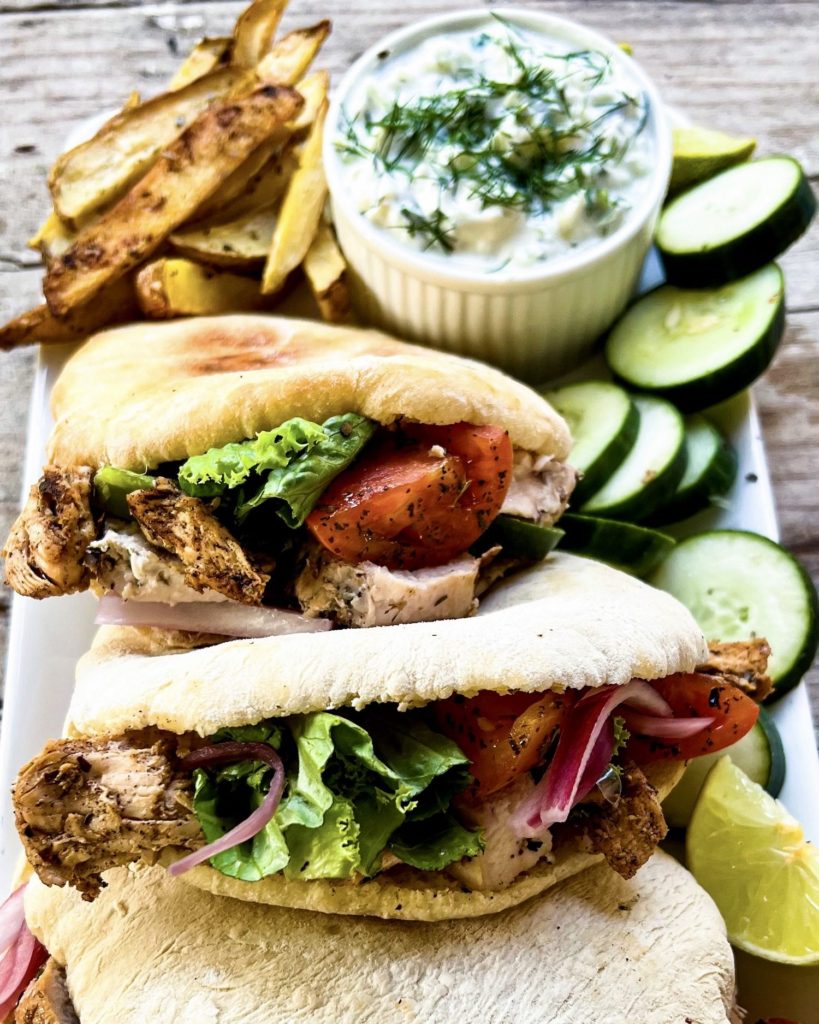 Lemon marinated chicken pitas with oven baked fries and tzatziki