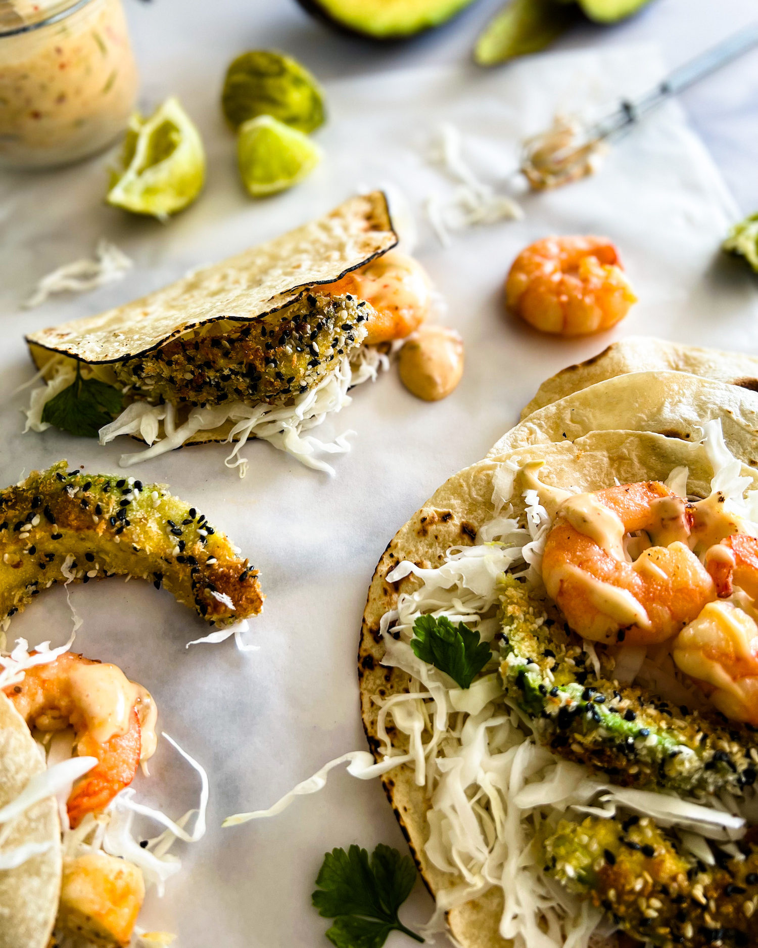 Sesame panfried avocado and shrimp tacos close up