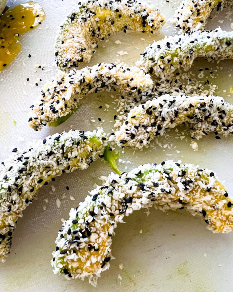avocado wedges dipped in egg and rolled in panko and sesame seeds