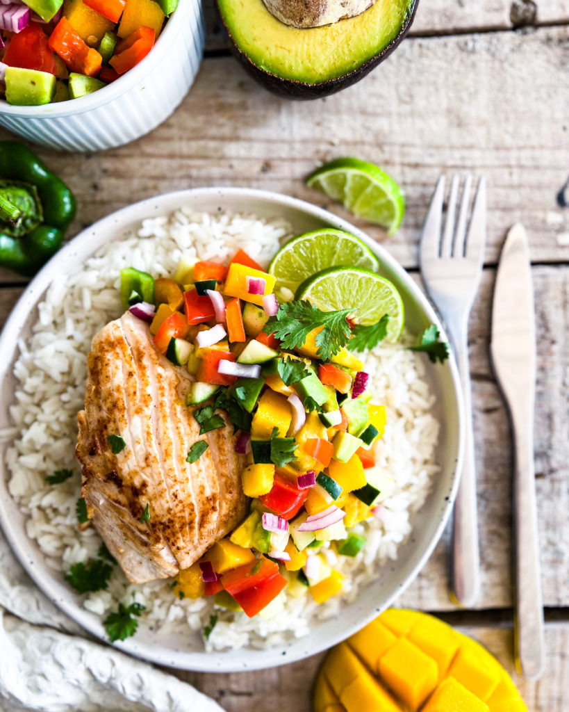 a close up of cilantro lime fish filets with mango salsa