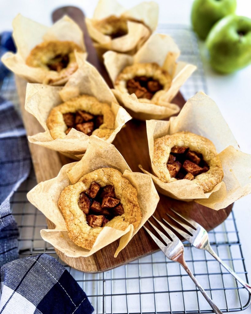 6 mini apple pies on a cutting board