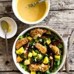 chicken finger salad in a bowl with dressing on the side