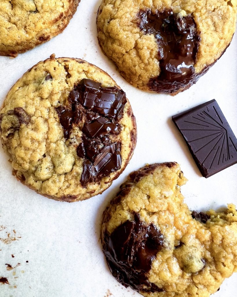 A close up of some cakey chocolate chip cookies with extra chocolate chunks