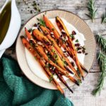 Roasted carrots on whipped ricotta topped with pecan herb crumble and maple glaze on the side