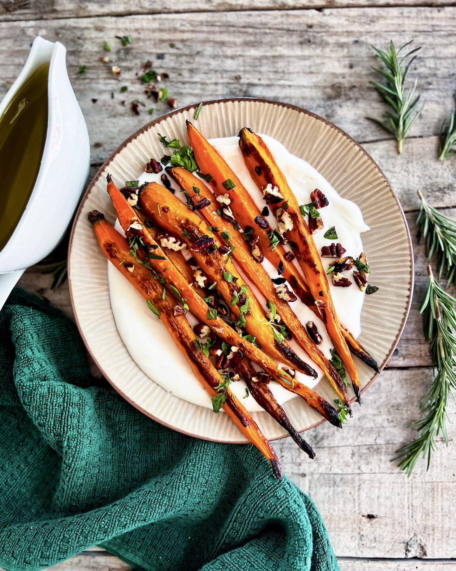 Roasted carrots on whipped ricotta topped with pecan herb crumble and maple glaze on the side