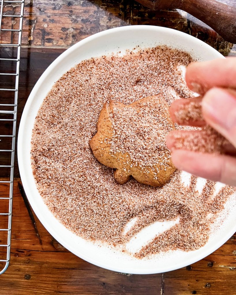 adding chai spiced sugar to a baked cookie