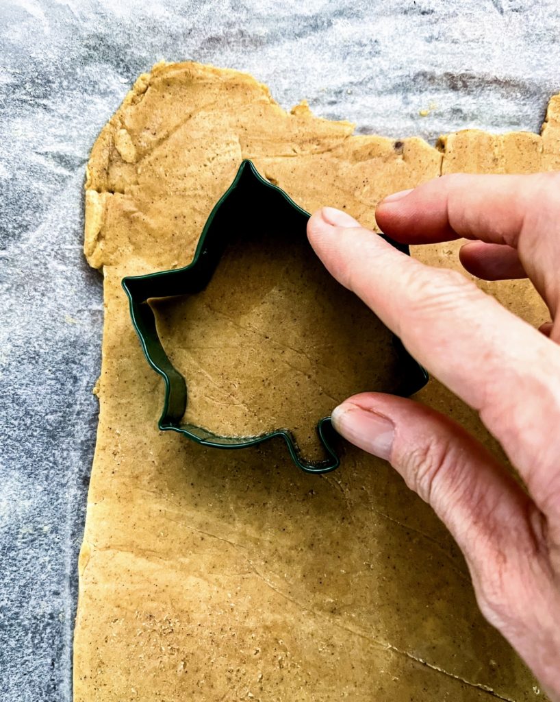 cutting out a spiced cookie with a cookie cutter