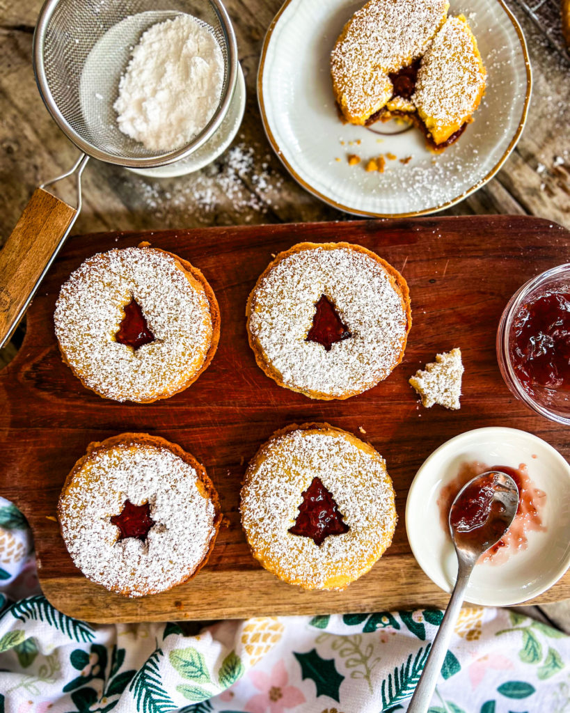 linzer cookies filled with raspberry jam and dusted with powdered sugar close up