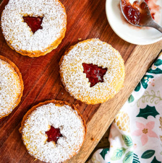 linzer cookies filled with raspberry jam and dusted with powdered sugar close up