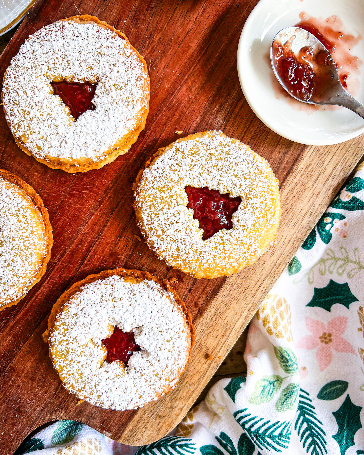 linzer cookies filled with raspberry jam and dusted with powdered sugar close up