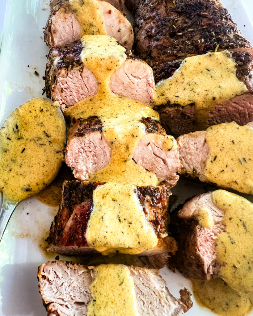 close up of mustard sauce poured over tenderloin medallions