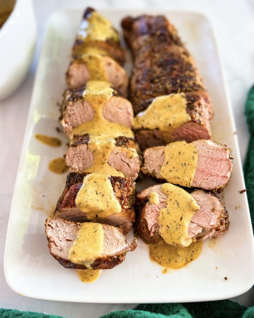 mustard sauce poured over tenderloin medallions