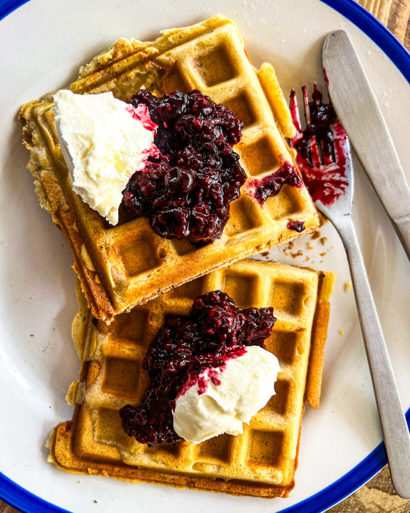 two waffles with berry compote and labneh